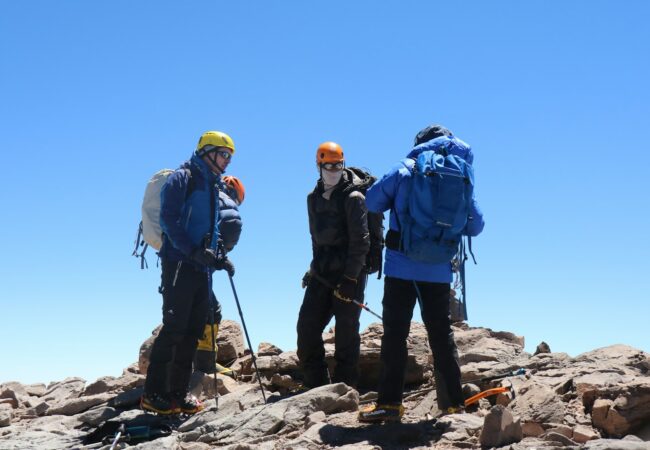 three trekkers during daytime