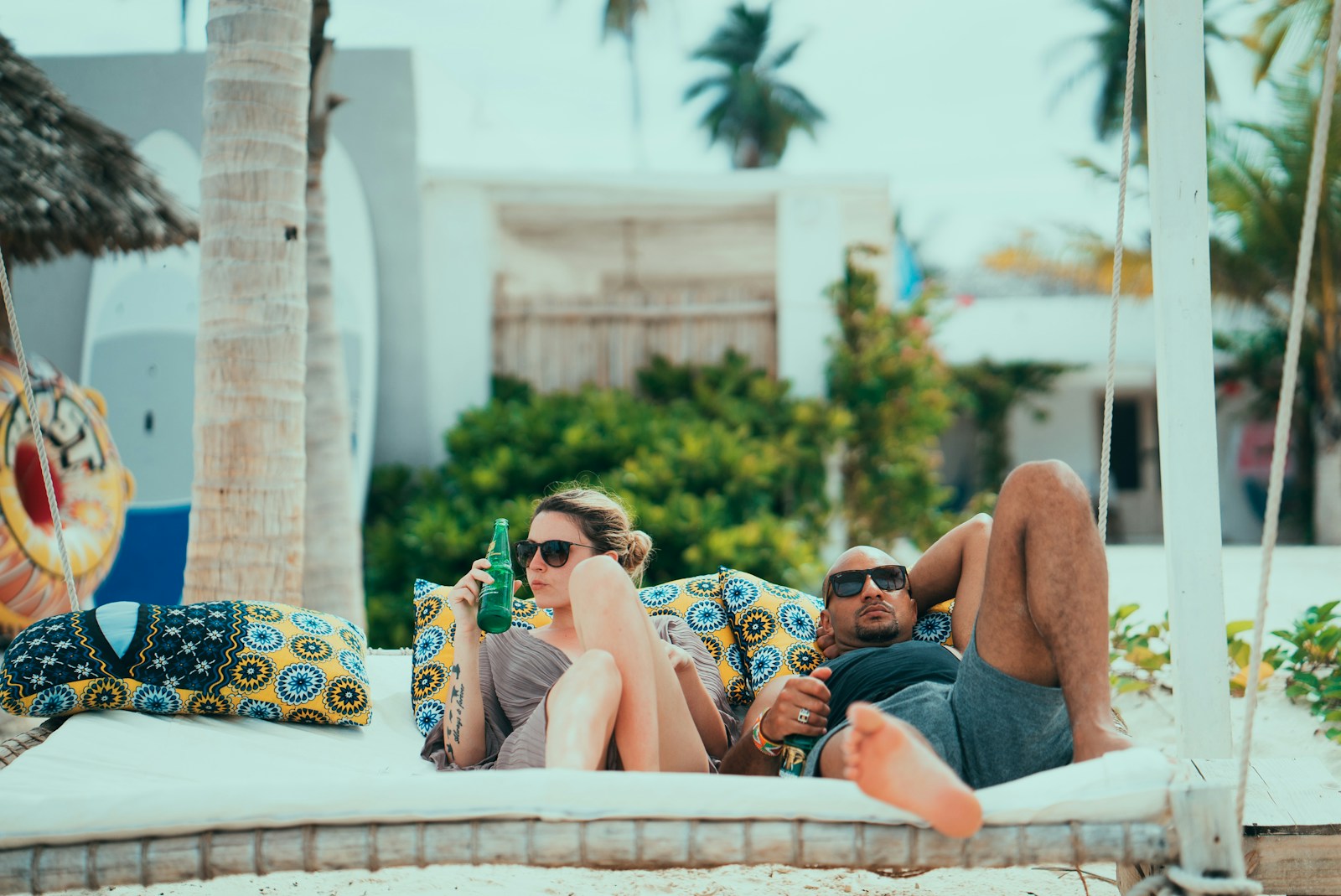 man and woman lying on lounge