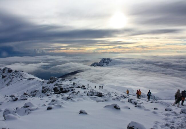 people on snow covered mountain during daytime